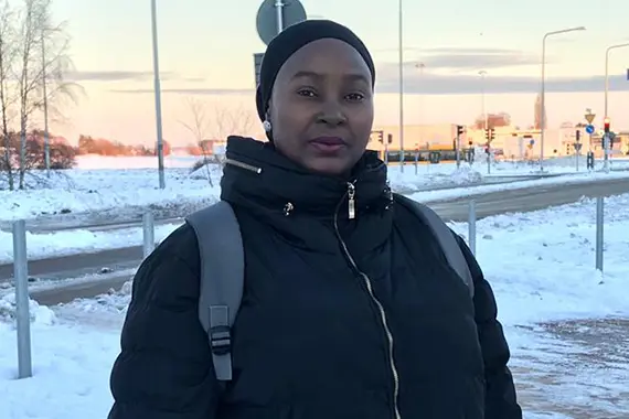 Aisha standing outside, snow on the ground