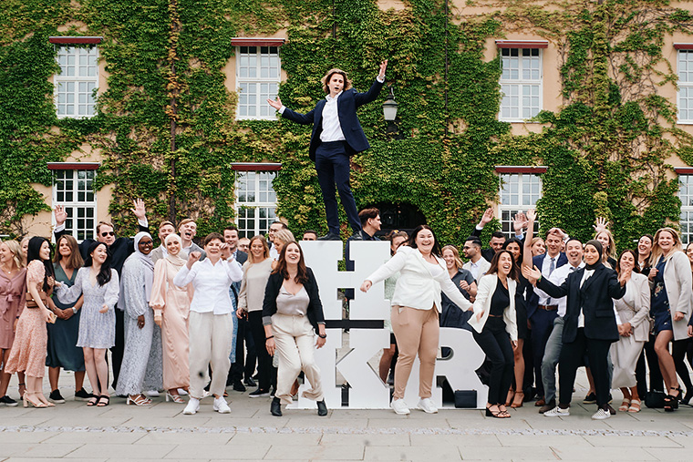 Studenter firar vid HKR-bokstäverna.